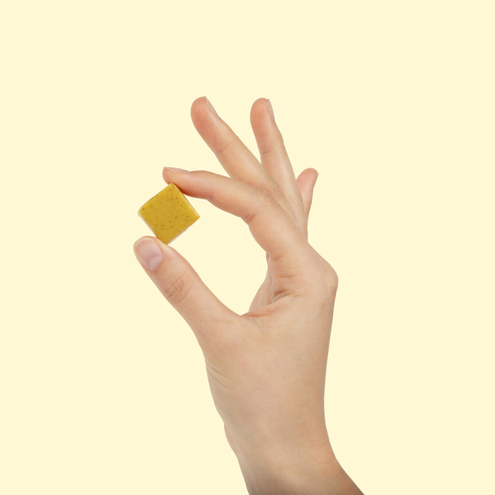 Hand holding WonderBee Superfood & Greens Honey Chews