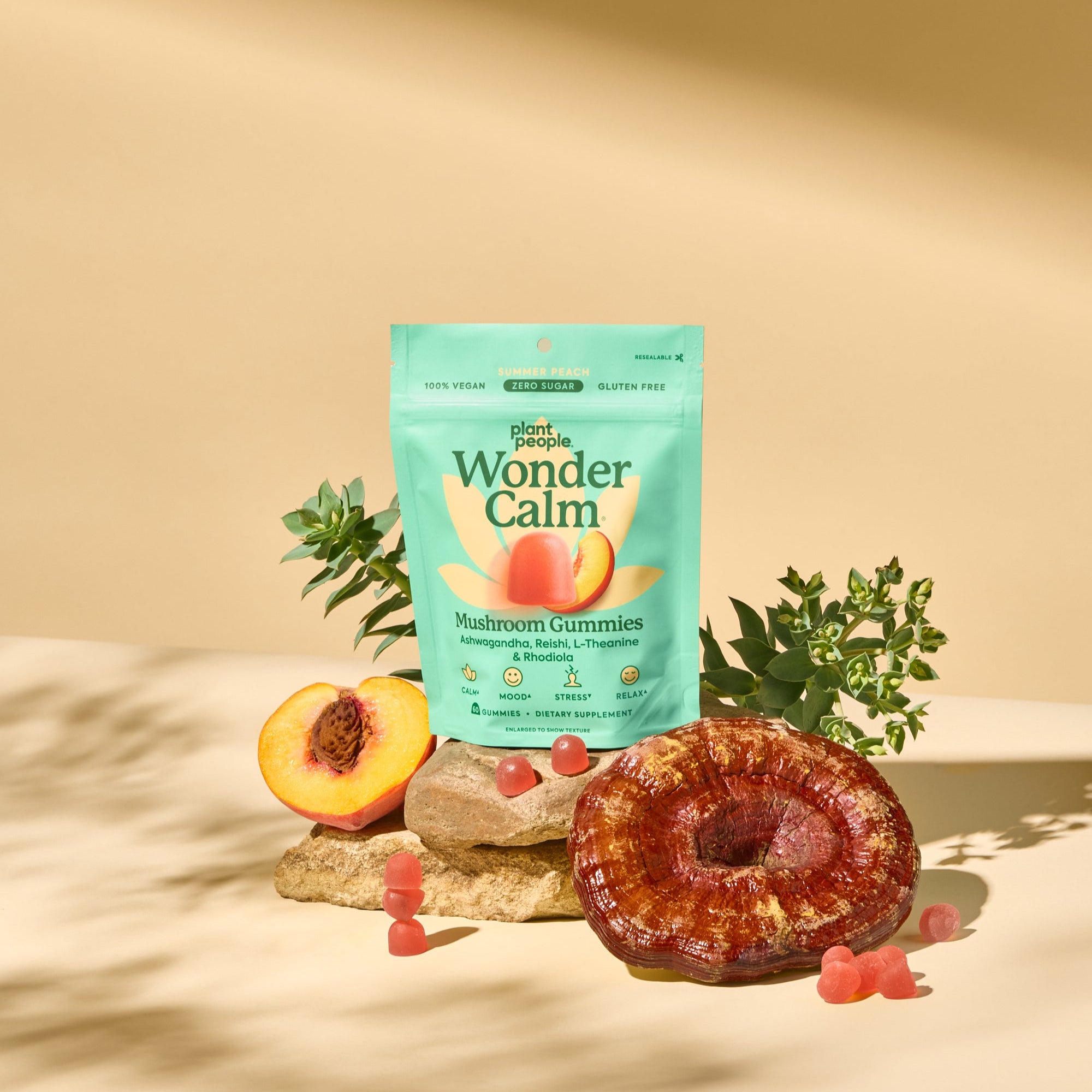 Wonder Calm gummies packaging with a reishi mushroom and peach on a beige background