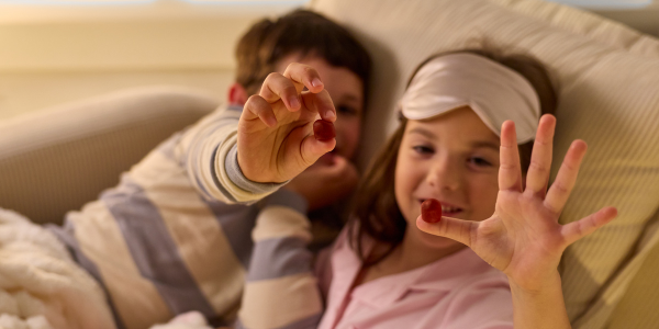 two kids age 6 holding gummies